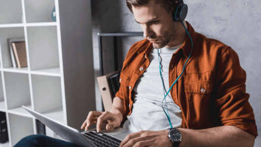 young man working on headphones at home