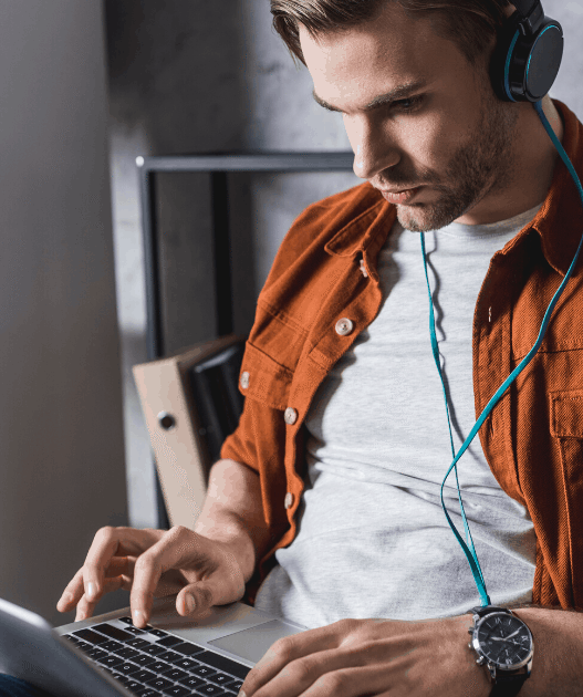young man working on headphones at home